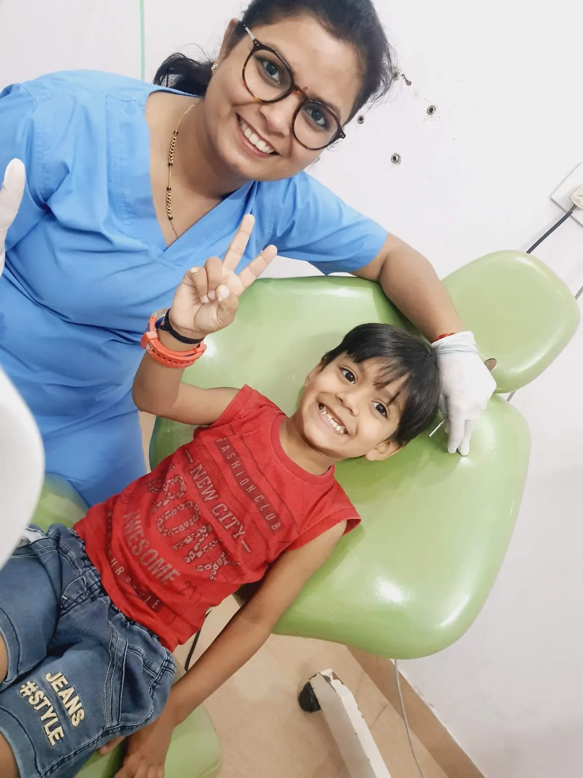 Dr. Jahanvi Tyagi with a smiling young patient in the dental chair