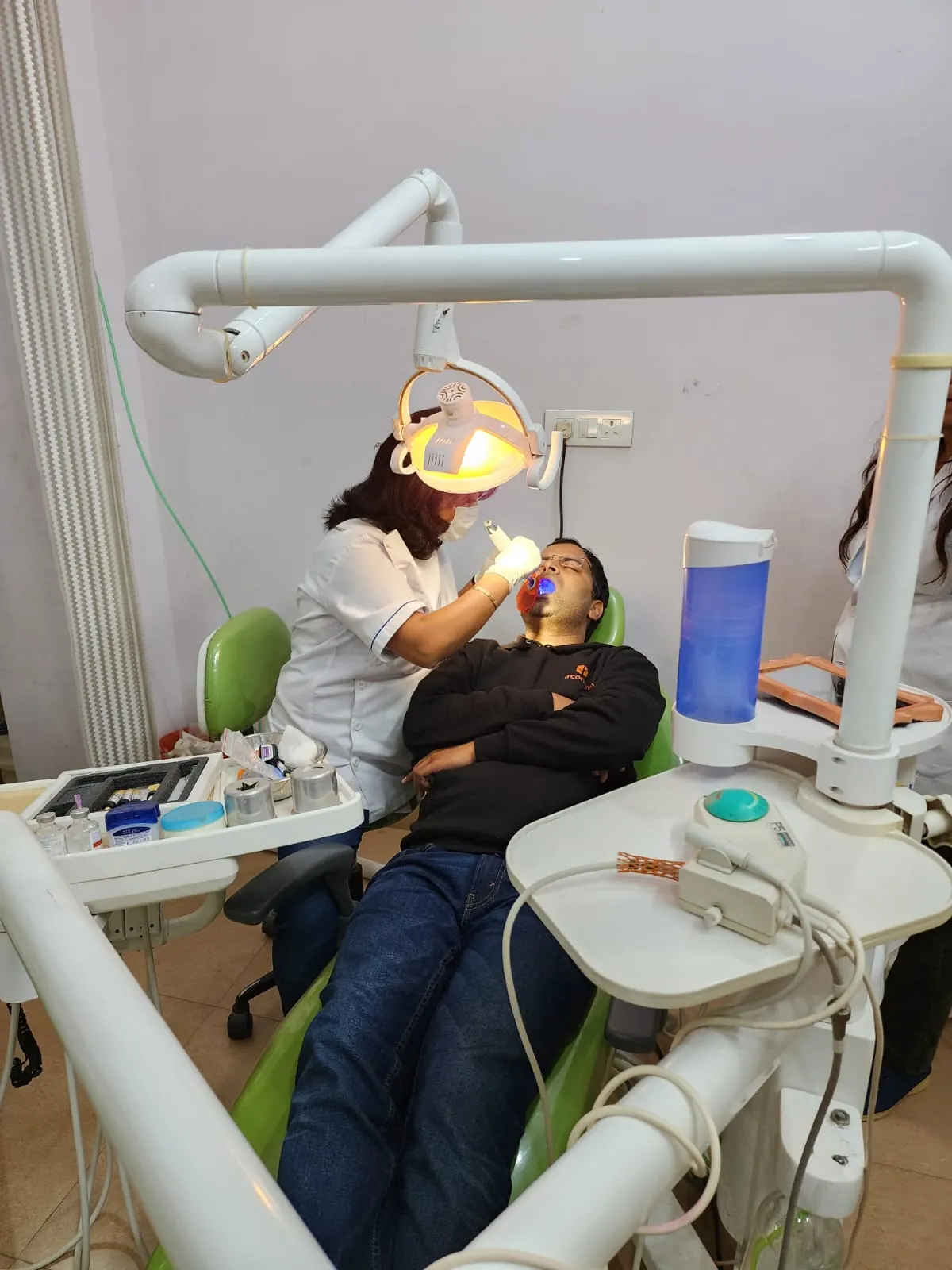 Dr. Jahanvi Tyagi working on a patient under the dental light