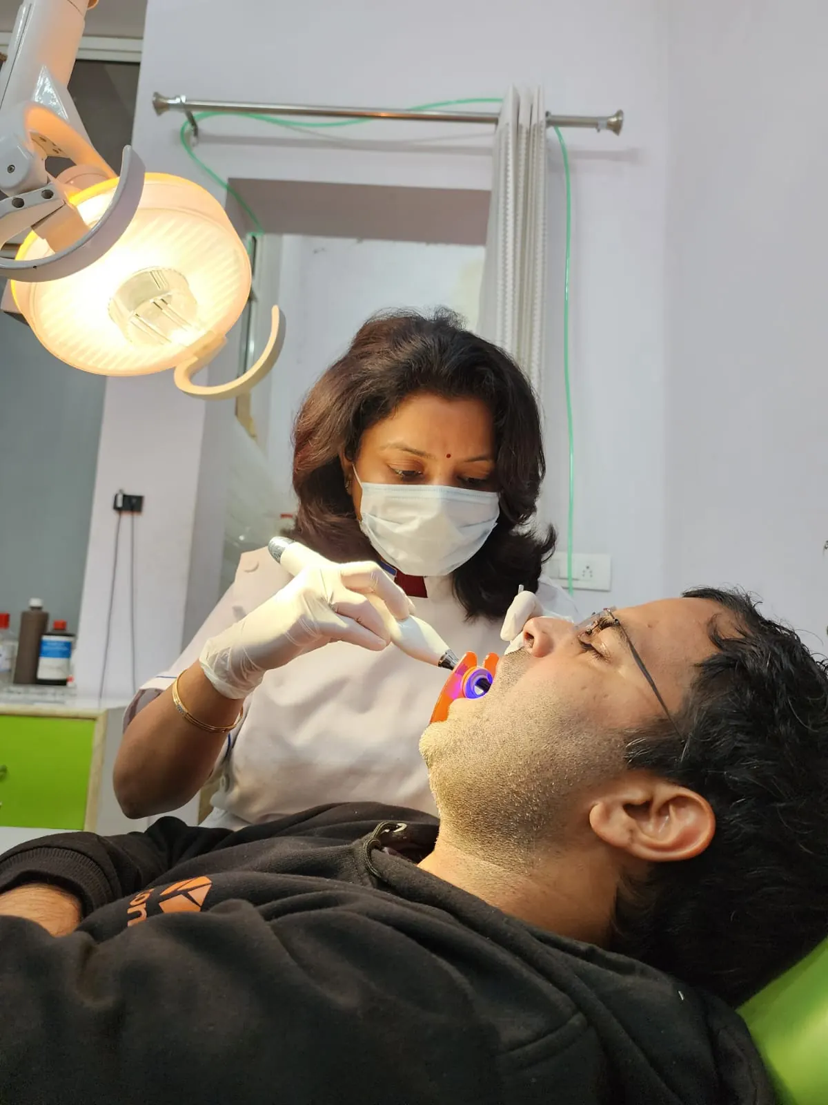 Dr. Jahanvi Tyagi examining a patient's teeth