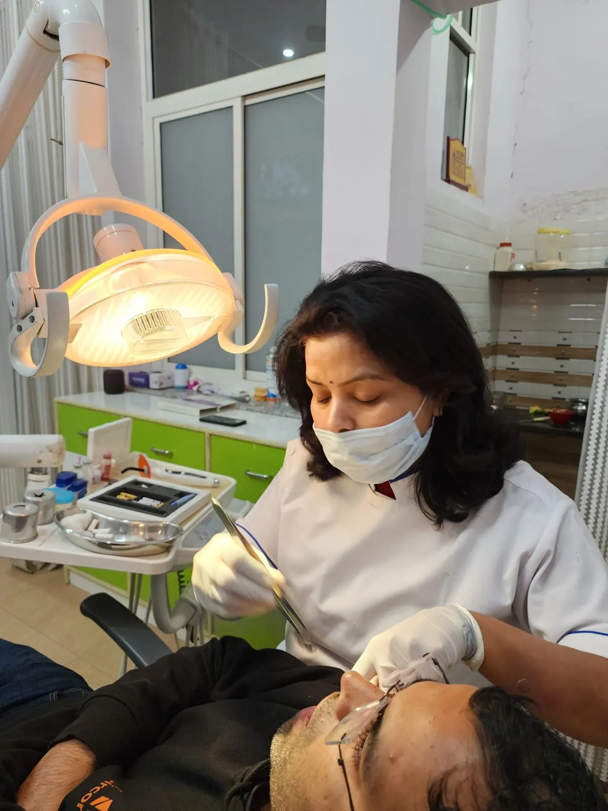 Dr. Jahanvi Tyagi treating a patient in the dental chair at the clinic