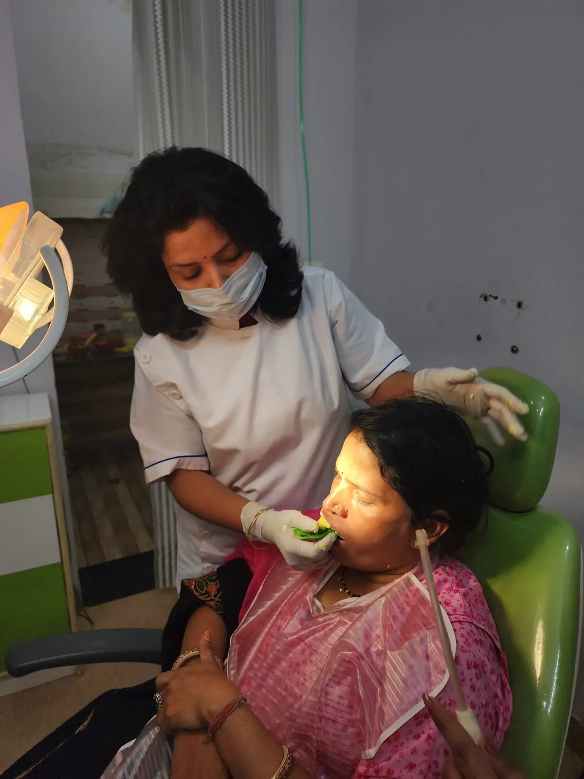 Dr. Jahanvi Tyagi treating a patient seated in the dental chair
