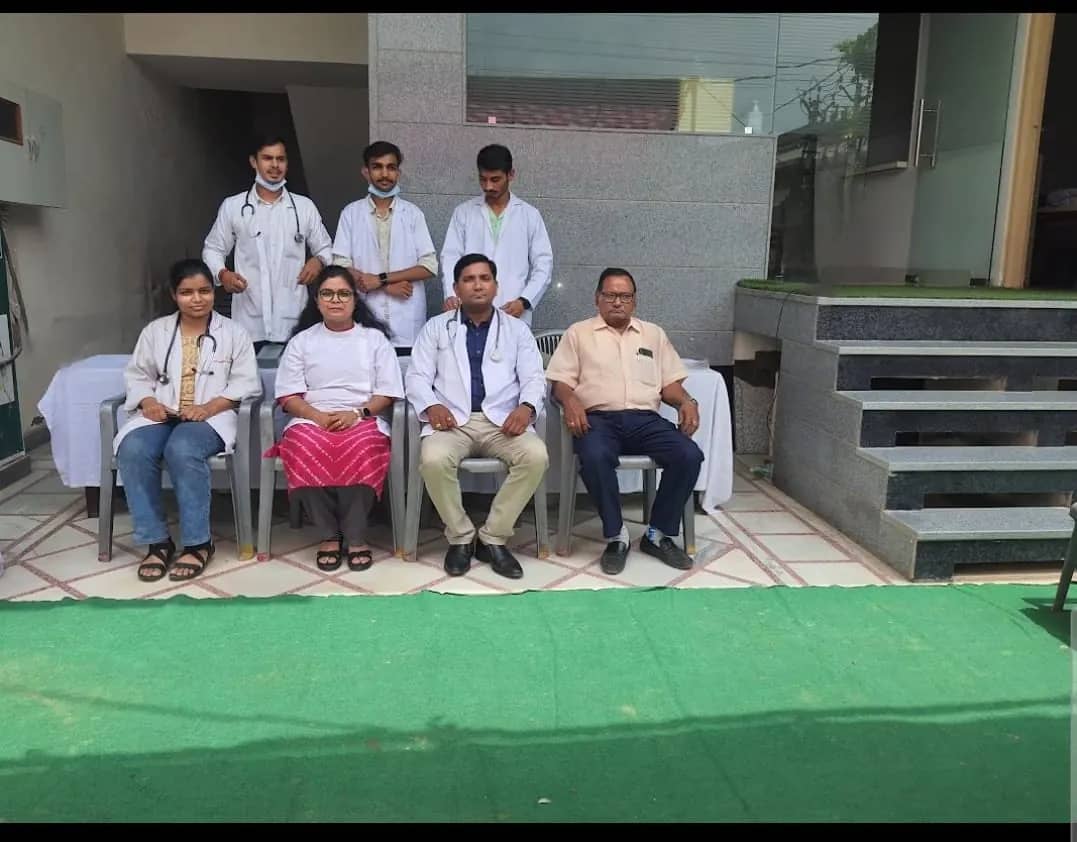 The clinic team seated outside the clinic