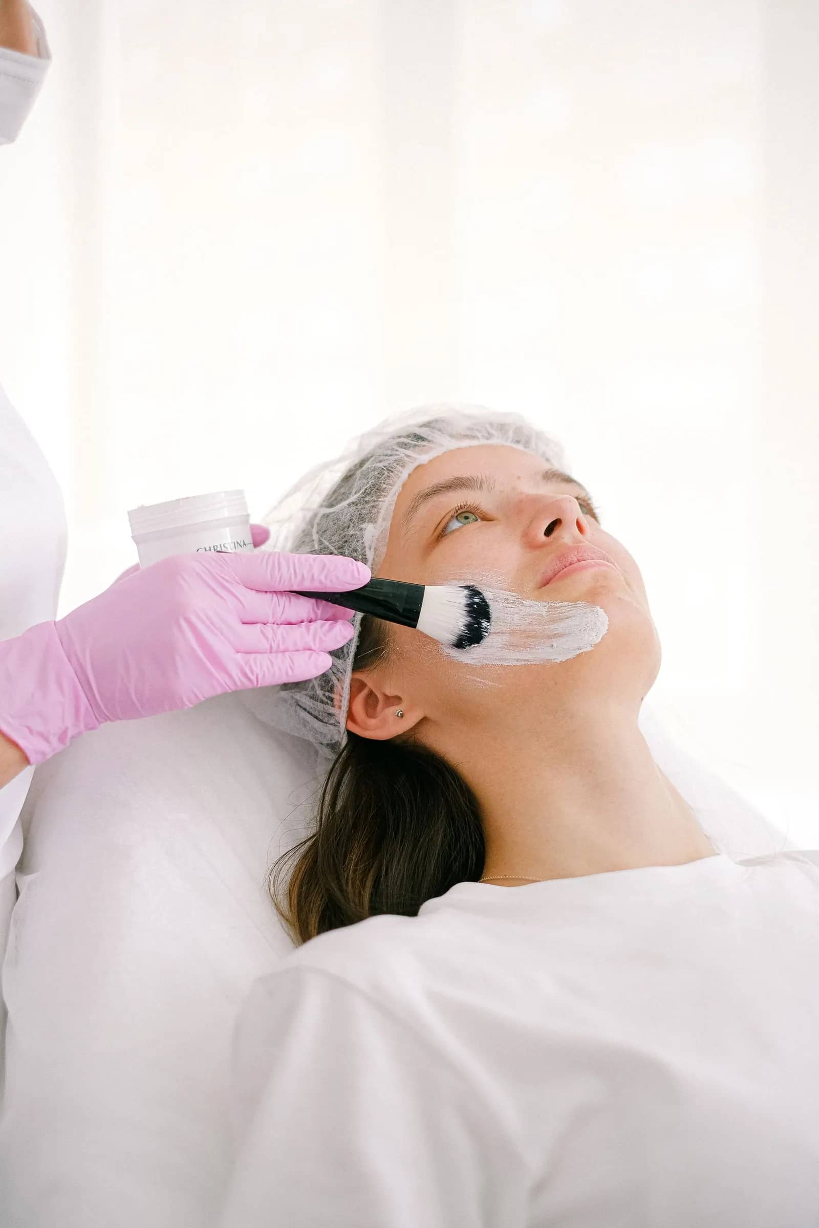 A peel solution being brushed onto a patient's face